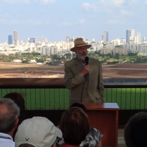 Martin Weill, addressing the Israel Bond delegation overlooking the Ariel Sharon Park being developed in the background.